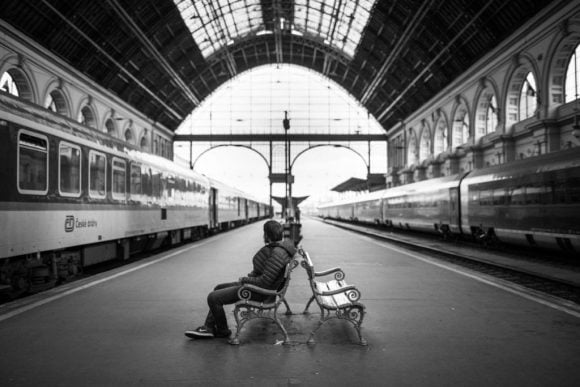 man-sitting-bench-seat-train-station-1024x683