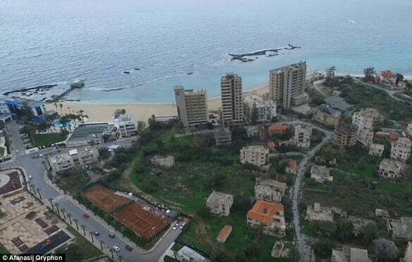 The abandoned buildings (right) look faded and worn compared to those that are still occupied by residents or businesses