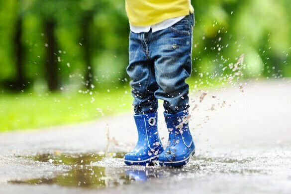 Toddler jumping in pool of water